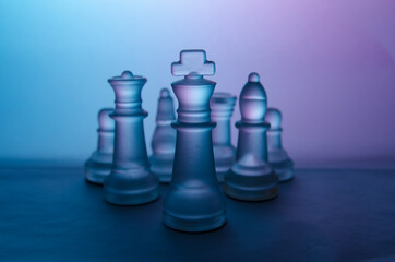 Group of colorful chess pieces led by the king 