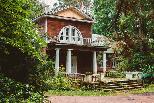 Two-story old wooden noble house  in the forest. The architecture of the estate of the nineteenth century in the style of classicism