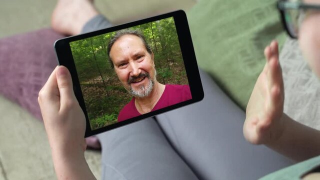Young woman having video call via tablet talking to dad. Friends, facetime, online, internet, long distance communication, chatting concept. skype chatting with father.