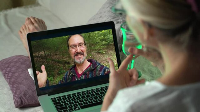 Blonde woman drinking wine and having video call via tablet talking to husband. Friends, facetime, online, internet, long distance communication, chatting concept. skype chatting.