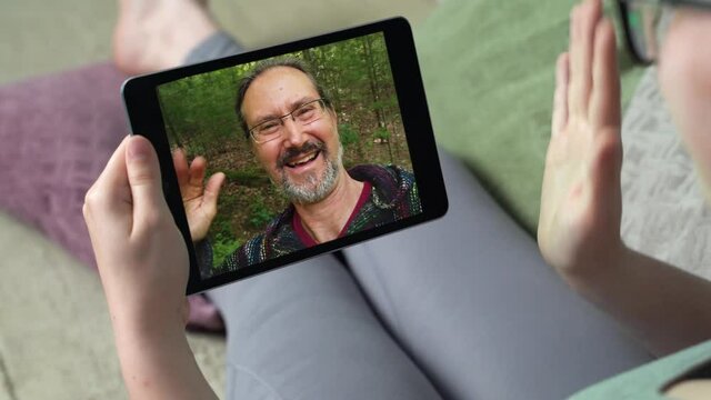 Young woman having video call via tablet talking to dad. Friends, facetime, online, internet, long distance communication, chatting concept. skype chatting with father.