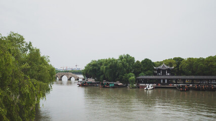 Fototapeta premium Bridge and boat dock in South Lake scenic area in Jiaxing, China