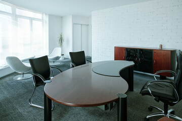 Interior of large contemporary boardroom with chairs around design table