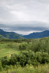 mountains on a background of green grass on a cloudy day mountain landscape
