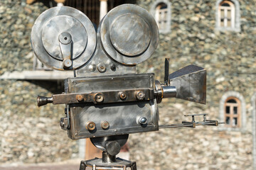 Vintage Cinema camcorder against the background of the castle walls, shooting an old-style film of...