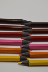 Colored wooden pencils on a white background