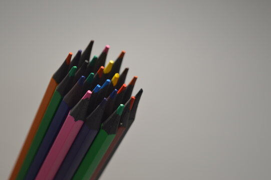 Colored wooden pencils on a white background
