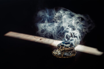 decorated incense with burning carbon and resins.