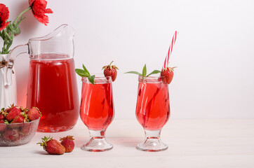 Summer cooling drink with strawberries and ice on a white background with copy space.