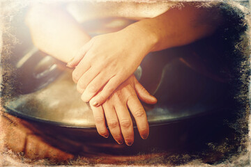 beautiful woman playing with hangdrum in nature. Old photo effect.