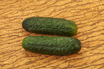 Green fresh cucumbers over background