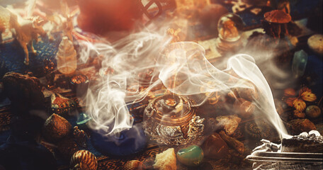 incense in a woman hand, incense smoke on a black background.