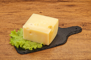 Emmental cheese over wooden board