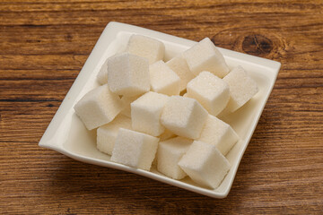Refined white sugar cubs in the bowl