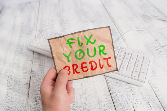 Conceptual Hand Writing Showing Fix Your Credit. Concept Meaning Improve Or Increase Your Rating Or Score To Get Money Loan Or Mortgage Man Holding Colorful Reminder Square Shaped Paper Wood Floor