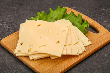 Sliced yellow cheese over board