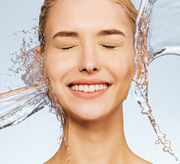Photo of  young  woman with clean skin and splash of water. Portrait of smiling woman with drops of...