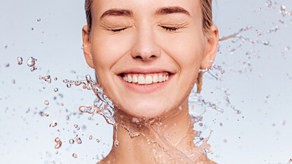 Photo of  young  woman with clean skin and splash of water. Portrait of smiling woman with drops of...