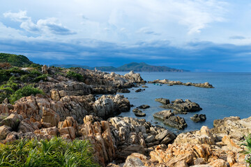 Fototapeta na wymiar Tropical beach with rocks and blue sea in Vietnam