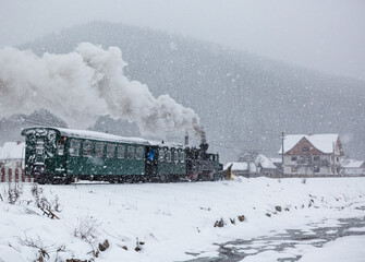 snow covered rural landscape  with vintage steam train