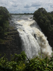 Scenic view of waterfall under cloudy sky, Victoria Falls, Zimbabwe