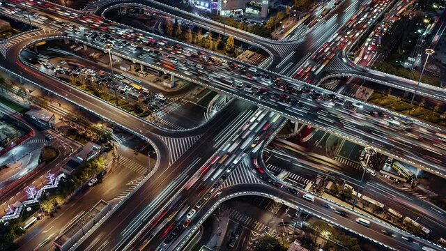 TL/PU Asia, China, Beijing, Aerial view Pan Up Time lapse of busy road intersection in Beijing's financial district, with  traffic and commuters during evening rush hour