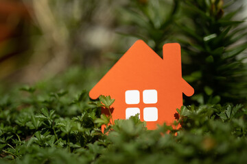 imply flat lay design with miniature white toy house