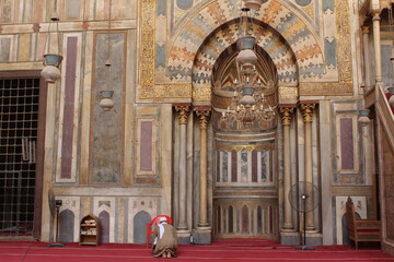 A man performing his prayer in the old beautiful decorated mosque of Sultan Hassan in Cairo