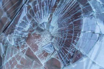 Broken glass, traces of shots in bulletproof glass display cases. Background texture