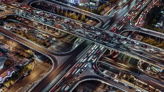 TL/ZI Asia, China, Beijing, Aerial view Zoom In Time lapse of busy road intersection in Beijing's financial district, with  traffic and commuters during evening rush hour