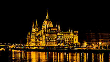 Fototapeta na wymiar A view of the illuminated eastern shore of the River Danube in Budapest at night in the summertime