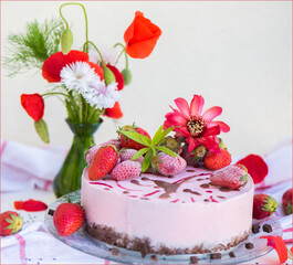 Strawberry mousse cake garnished with wild flowers - poppies, blueberries, verbena and cactus flower. The base is chocolate.