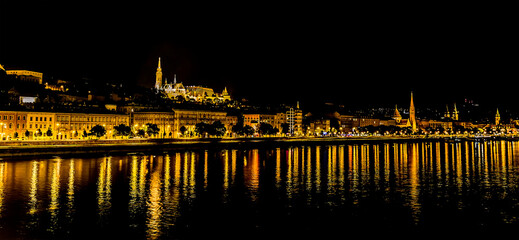 Fototapeta na wymiar A view from the Chain Bridge across the River Danube in Budapest at night towards the Buda district in the summertime