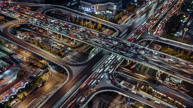 TL/ Asia, China, Beijing, Aerial view Time lapse of busy road intersection in Beijing's financial district, with  traffic and commuters during evening rush hour