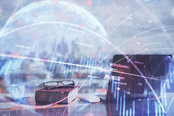 Double exposure of financial chart drawings and desk with open notebook background. Concept of forex market