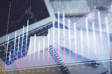 Double exposure of financial chart drawing and desktop with coffee and items on table background. Concept of forex market trading