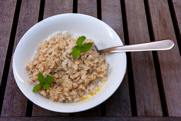 bio wholegrain porridge with butter, milk and fragrant mint