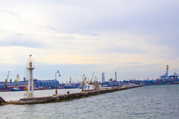 Dilapidated old fishing dock collapsing into the sea. Walking paths on the promenade. 