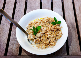 bio wholegrain porridge with butter, milk and fragrant mint