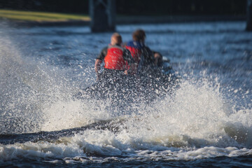 Naklejka premium View of jet ski in motion, group of jet skiers with a big water splash