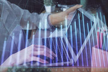 Double exposure of woman hands typing on computer and forex chart hologram drawing. Stock market invest concept.