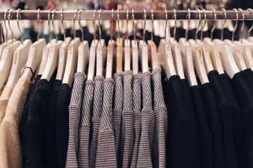 Clothes hang on a shelf in a designer clothes store