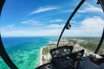Poster Helicopter cabin inside cockpit aerial top view on blue sky and water at the caribbean coast and atlantic ocean in Dominican republic, Punta Cana © Irina