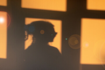 Indoors summer vibes - silhouette of a smiling woman in the afternoon light