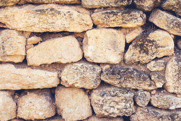 Close up of stone wall with cement. Texture of stonewall. Stones wall background. Antique natural stonewall.