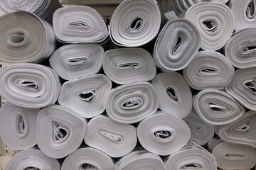Stacked rolls of insulating material material in warehouse