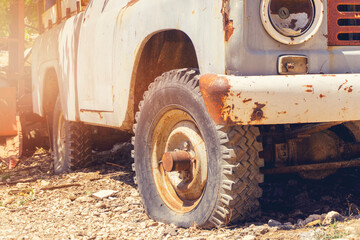 Old pickup truck with a wooden flat bed and weathered exterior.