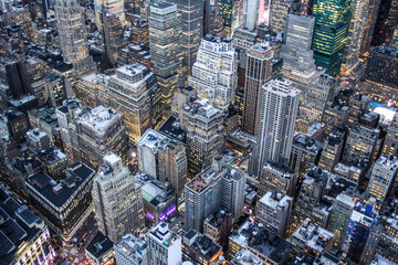 Illuminated New York skyline with skyscrapers seen from an aerial view