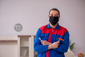 Young carpenter working indoors during pandemic disease