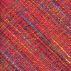 Closeup of colorful handwoven fabric with red weft